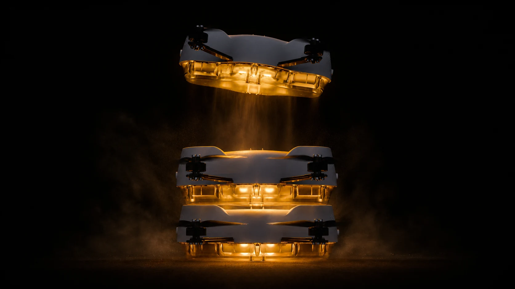 Three stacked Spectra drones landing in illuminated golden smoke